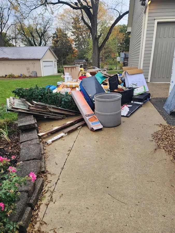 Dumpster being loaded with debris for Roofing Dumpster Rental in Silver Spring